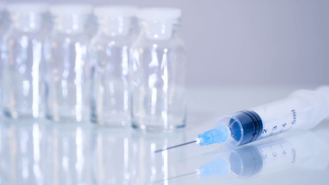 Needle and jars on table