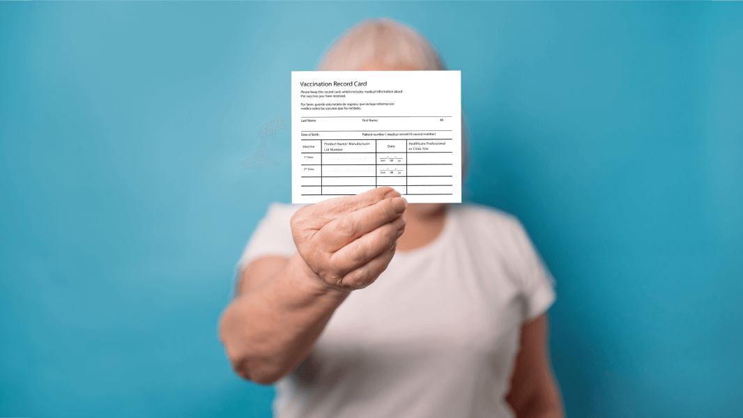 Patient holding up vaccination record card
