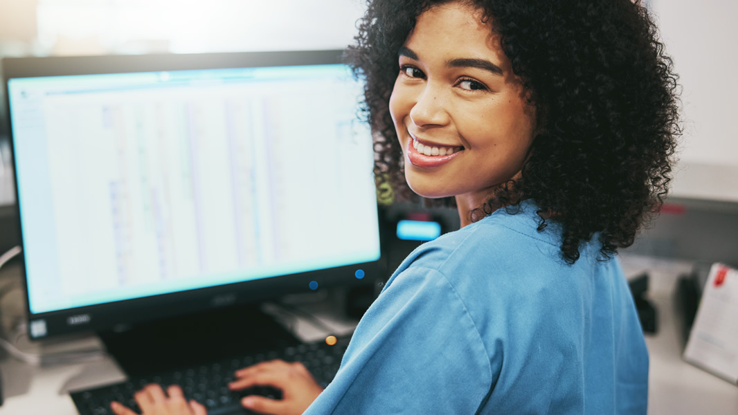 Smiling Nurse on Computer