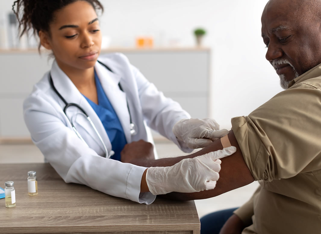 Healthcare professional applying plaster on patient’s arm